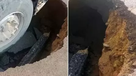 Грузовик ушел под землю на дырявой дороге в Алматы